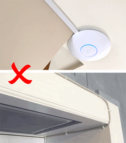 An access point on a shelf with a cable hanging from it